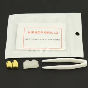 Set of hip hop gold grillz featuring two canine fangs, tweezers, and silicone molding bar