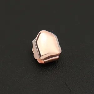 Detail of a rose gold single tooth grillz with glossy finish for hip hop street style