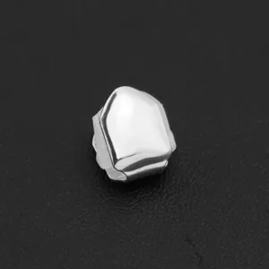 Close-up detail of a silver smooth single tooth grill cap for hip-hop style