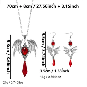 Set di gioielli gotici vintage con ali di pipistrello e gocce di cristallo rosso.