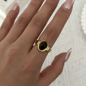 Anello vintage in oro con pietra occhio di tigre ovale indossato su una mano