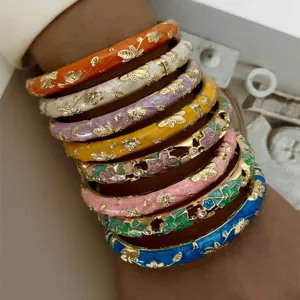 Set of 8 colorful ethnic style enamel bangles with gold floral and crystal accents