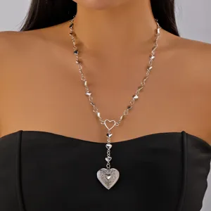 Close-up of the silver heart pendant necklace on a model showing intricate detail