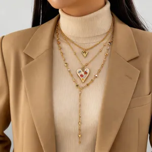 Detailed shot of multi-layered gold heart pendant necklaces on a model's neck.