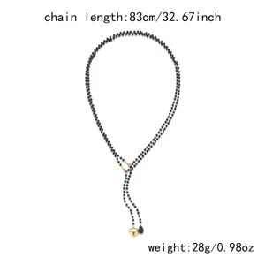 Detailed view of black beaded necklace with heart pendant and size specifications