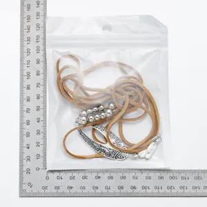 Detail view of Western-style hollow silver pendant with brown faux-suede cord