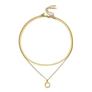 Minimalist layered gold necklace with herringbone chain and oval pendant detail view
