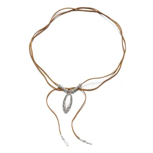 Detailed view of Bohemian brown suede cord necklace with silver hollow oval pendant