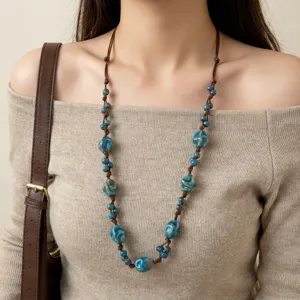 Close-up detail of Bohemian adjustable necklace with blue ceramic beads on brown cord