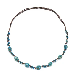 Detailed view of bohemian adjustable necklace with blue ceramic beads on brown cord