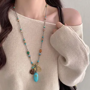 Close-up detail of Bohemian Western-style necklace with turquoise pendant and beads