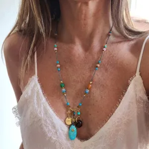 Detailed view of a Bohemian necklace with colorful beads and a turquoise pendant
