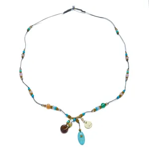 Detail view of colorful bohemian beaded necklace featuring multi-charms and grey cord