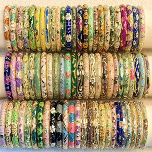 Detailed view of vintage enamel bangles with colorful floral and geometric patterns.