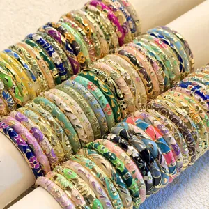 Detailed close-up of retro Chinese enamel floral bangles in a variety of vibrant colors.