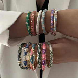 Detailed shot of vibrant vintage enamel bangles with floral and geometric patterns