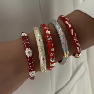 Detailed close-up of traditional Chinese enamel bangles featuring colorful floral patterns
