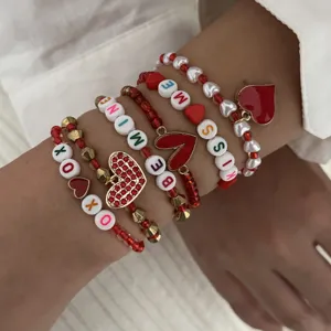 Detailed view of Valentine's Day stacked beaded bracelet set with red heart charms