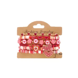 Handmade Valentine's Day stacked bracelet set featuring red heart charms and clay beads