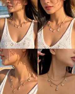 Detail view of golden beach-style necklaces with starfish and shell charms.