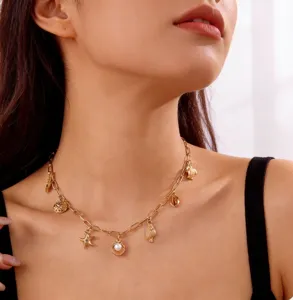 Close-up detail of beach style necklace with starfish shell and pearl charms on model