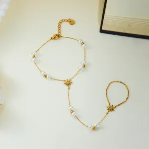 Élégant bracelet de main doré orné d'étoiles à huit branches et de perles délicates