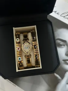 Gold evil eye watch set with almond dial and elastic charm bracelets in black gift box