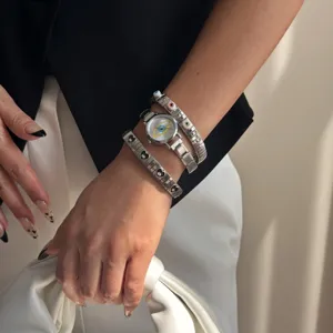 Retro silver evil eye wristwatch paired with heart pattern elastic metal bracelets.