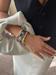 Elegant close-up of an angular black dial watch and crystal-studded stretch bracelets