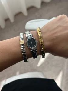 Elegant silver steel watch with black dial paired with crystal-set elastic bracelets