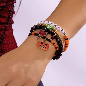 Detailansicht eines Halloween-Armbandsets mit Kürbis- und Totenkopfanhängern für Damen