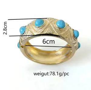 Wide Bohemian gold-textured bangle with blue resin stones, 6cm diameter detail view.