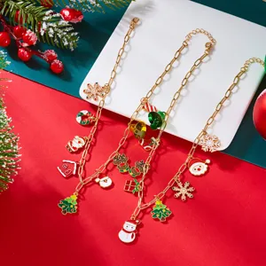 Detail of Christmas jewelry featuring enamel Santa, reindeer, and tree charms on gold chains.
