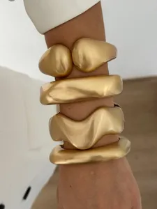 Minimalist matte gold geometric wave metal bracelets with brushed texture details