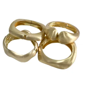 Minimalist matte gold geometric metal bracelets with brushed texture and wavy design