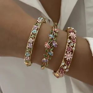 Vintage enamel flower bangles with hollow vine design and colorful floral detail accents