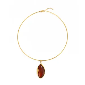 Elegant gold-tone thin choker necklace featuring a dark amber resin teardrop pendant.