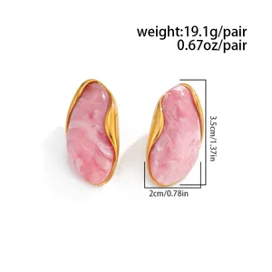 Detailed view of pink marbled earrings with golden wave edges and size measurements