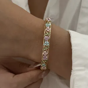 Exquisite detail of a vintage enamel floral bangle featuring colorful vine patterns