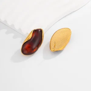 Detailed view of vintage gold irregular wave edge amber stud earrings front and back.