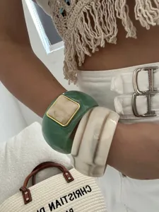 Vintage style resin bangles with marbled texture and gold-framed square detail on arm