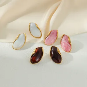 Irregular wavy gold-trimmed resin stud earrings set in white, pink and amber.