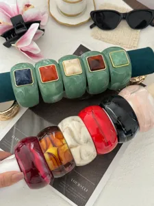 Group of vintage marbled resin bangles with square cube accents in various vibrant colors.