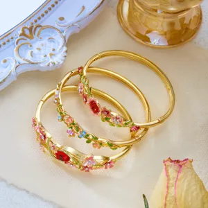 Detail of vintage enamel floral bangles with intricate vine patterns and colorful flower designs.