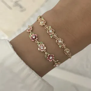 Close-up view of vintage enamel floral bracelets with crystal accents and hollow vine detail