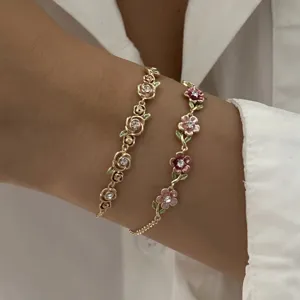 Detail of vintage enamel floral bracelets featuring roses and colorful vine flowers