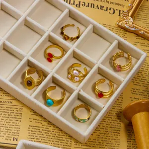 Collezione di anelli dorati vintage con pietre preziose in un vassoio di velluto