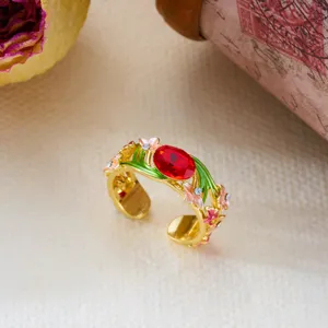 Detailed macro shot of a vintage gold-plated enamel floral ring with a red stone