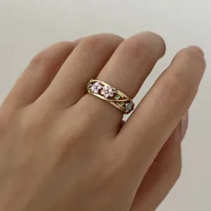 Detailed close-up showing a vintage enamel flower ring with intricate hollow vine design