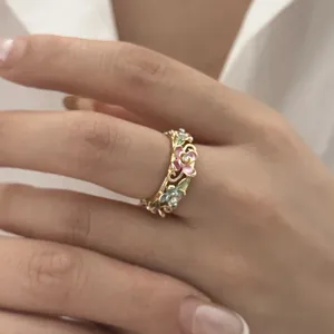 Detailed close-up of a vintage golden enamel flower ring featuring hollow vine patterns